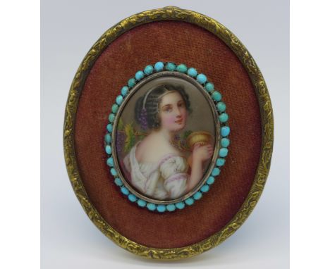 An easel back gilt framed portrait brooch mounted in an oval frame with turquoise set surround, 8cm x 6.5cm