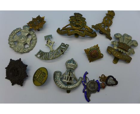 A silver and enamel Royal Artillery sweetheart brooch, lacking pin, and other military badges, etc.