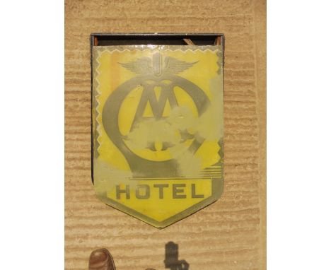 An AA Hotel enamel sign by Franco, with associated metal frame, part way through restoration.