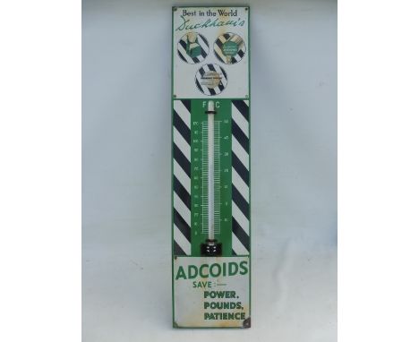 A Duckhams Adcoids black and white enamel thermometer, 11 x 45 1/2".