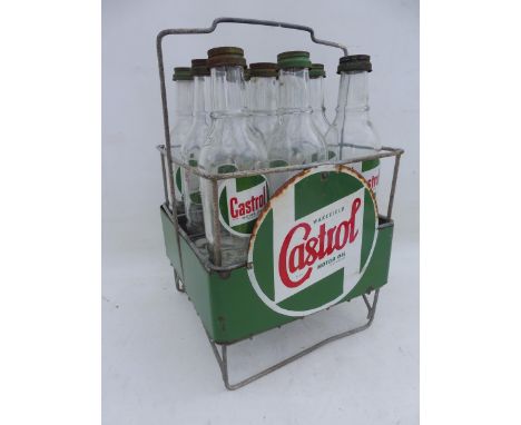 A Wakefield Castrol Motor Oil nine division crate with two wrap-around enamel signs and nine correct oil bottles with caps.