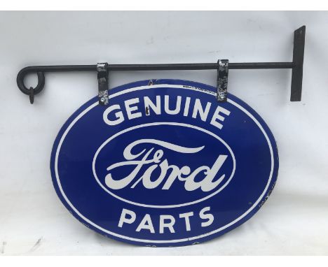 A Ford Genuine Parts oval double sided American enamel sign, stamped Made in USA hanging on a metal bracket, measurements for