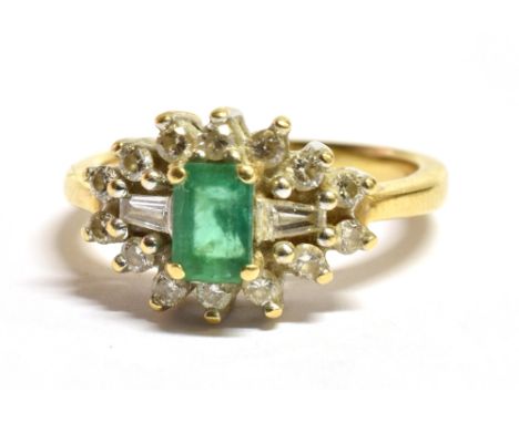 AN 18CT GOLD, EMERALD AND DIAMOND CLUSTER RING  The step cut Emerald measuring 0.7cm by 0.5cm and flanked each side by a bagu