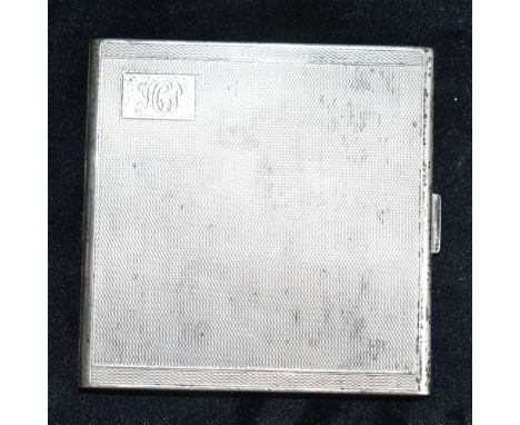 A SILVER CIGARETTE CASE  of engine turned pattern with a monogrammed cartouche and hallmarked for Birmingham 1929, with inter