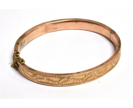 A LATE VICTORIAN 9CT ROSE GOLD HALF PATTERNED BANGLE hallmarked for Birmingham 1900 and fitted with a safety chain diameter 5