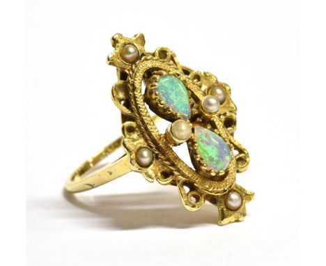 A MARKED 14KT OPAL AND SEED PEARL ORNATE NAVETTE RING  the navette set with two pear shaped opals and six seed pearls in an o