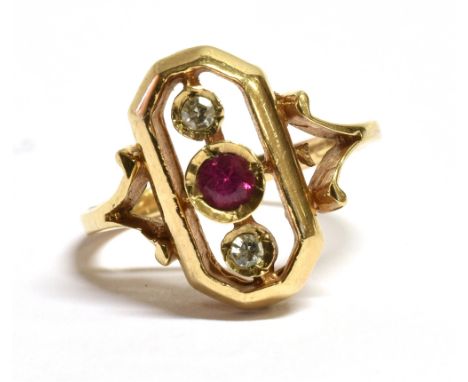 A 9CT GOLD RECTANGULAR DIMAOND AND RUBY PLAQUE RING The plaque measuring 1.6cm by 0.9cm with rounded corners set with a centr