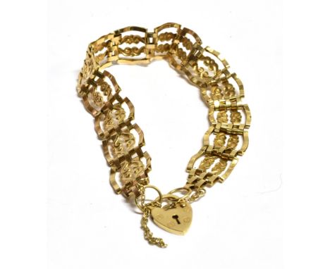 A 9CT GOLD HEART PADLOCK  Four gate fancy link bracelet with safety chain, the padlock hallmarked for London 1970, Maker ASJ,