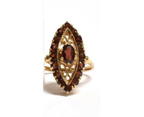 A MARKED 9CT GOLD GARNET NAVETTE RING The Navette measuring 2.2cm by 1.1cm at widest point, the central Garnet measuring 0.7c