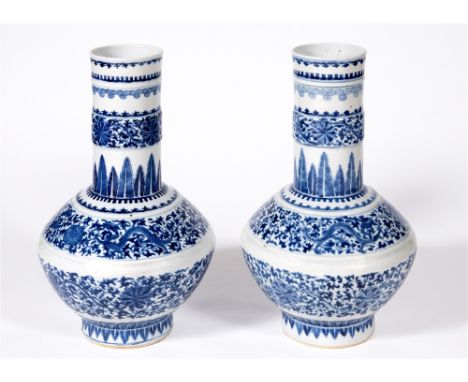 A LARGE PAIR OF CHINESE BOTTLE VASES the neck and angled globular body decorated with bands of trailing peonies, bearing six 