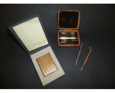 *Gold. A gold propelling cigar piercer, by Hockley Hill, Birmingham, stamped '375', with suspension ring, approx. 5.8g, a sim