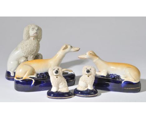 *Staffordshire. A pair of Victorian Staffordshire pottery pen rests modelled as recumbent greyhounds,  23cm long, together wi