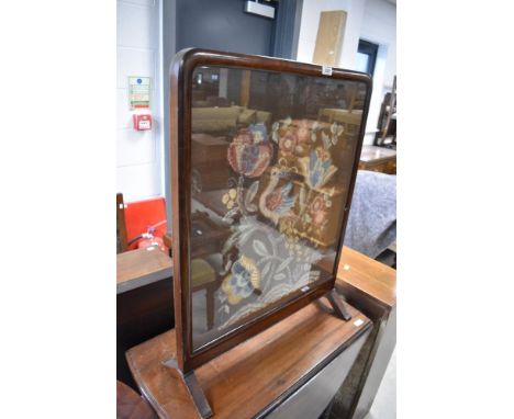 An antique tapestry firescreen