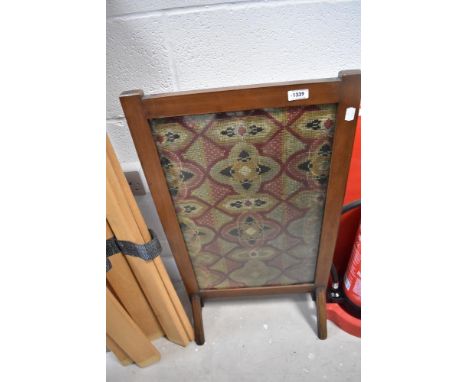 An Edwardian mahogany fire screen having tapestry inset
