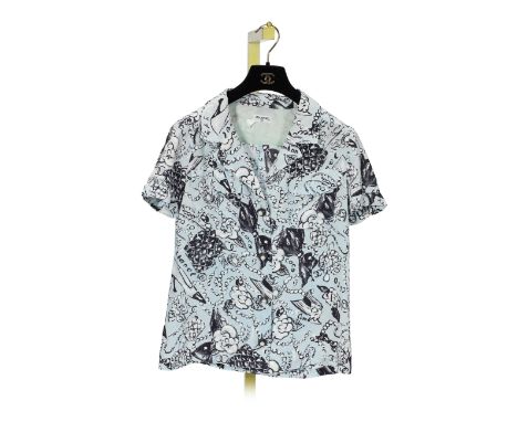 CHANEL: A BABY BLUE PRINTED SILK BLOUSESpring/Summer 1993Blue crepe silk with white pearl, camellia and bow design, black and