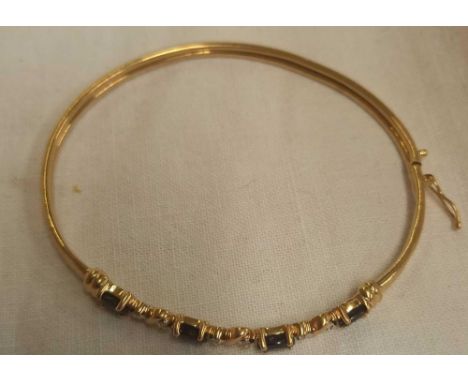 A SAPPHIRE &amp; DIAMOND 10 STONE BANGLE SET IN 9ct