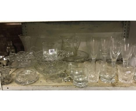 SHELF OF GLASSWARE INCL; CHAMPAGNE FLUTES, WHISKY GLASSES, GLASS CAKE STANDS &amp; VASES