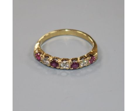 An 18ct gold, seven stone ruby and diamond half hoop ring, size P/Q.