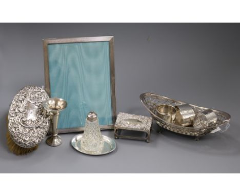 A small collection of silver and silver-mounted items, including a pair of embossed silver-backed oval brushes, a photograph 