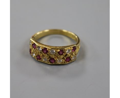 A modern 18ct gold and twin row ruby and diamond half hoop ring, size M.