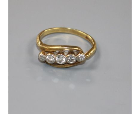 An 18ct gold and platinum, graduated five stone diamond ring, size K.