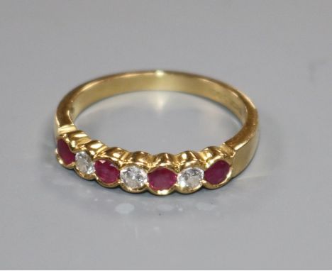 An 18ct yellow gold, ruby and diamond seven-stone ring, collet-set size P/Q.