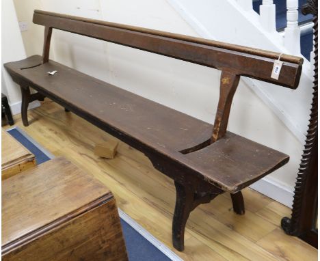 A late Victorian / Edwardian pitch pine railway bench with adjustable back W.273cm