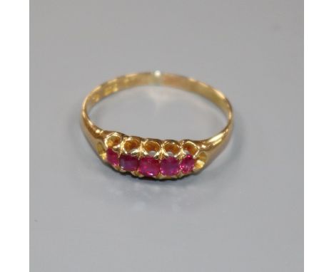 An early 20th century 18ct gold and graduated five stone ruby half hoop ring, size Q.