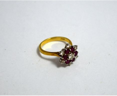 AN 18CT GOLD DIAMOND AND RUBY CLUSTER RING, designed as a daisy shape cluster, estimated total diamond weight 0.30ct, hallmar