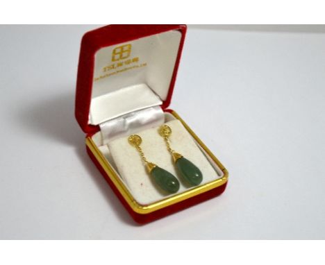 A PAIR OF JADE EAR PENDANTS, with tear drop shape jade suspended from Chinese openwork symbols