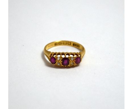 A VICTORIAN 18CT GOLD RUBY AND DIAMOND RING, with three rubies flanked by diamond accents to the plain tapered band, hallmark