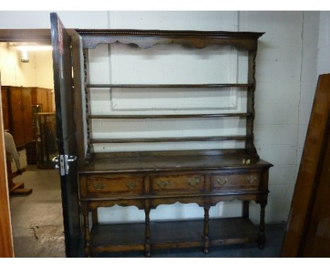 A RECENT OAK AND MAHOGANY CROSSBANDED DRESSER, the three tier plate rack above a three drawer base with lower shelf, approxim