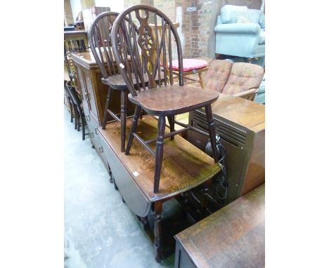 AN OAK GATE LEG TABLE, and two wheel back chairs (3)