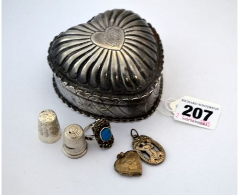 A SILVER HEART SHAPE TRINKET BOX, (marks rubbed), with two thimbles, a pendant ring and locket