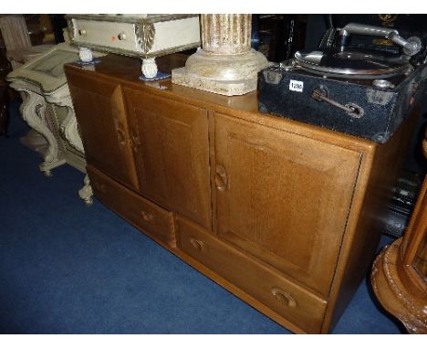 AN ERCOL BLONDE ELM SIDEBOARD, with triple doors above twin lower drawers