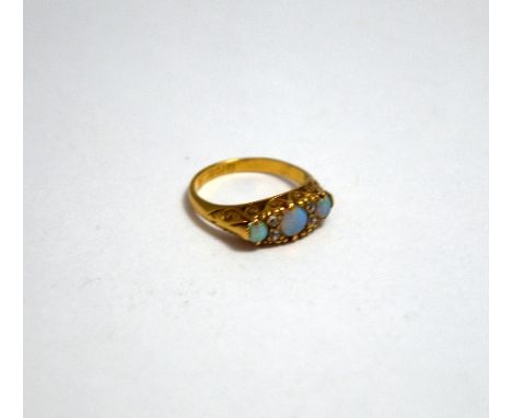 AN 18CT GOLD OPAL AND DIAMOND RING, with three graduated circular opals and old cut diamond accents, to the scrolling fancy t