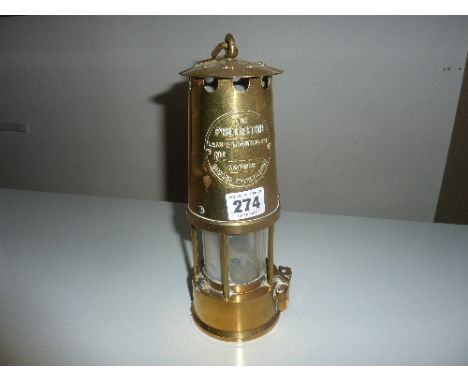 A BRASS PROTECTOR LAMP