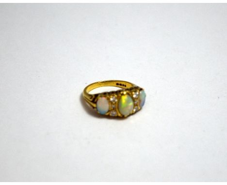 AN 18CT GOLD OPAL AND DIAMOND RING, with three large oval opals to a trio of brilliant cut diamonds either side of the centra