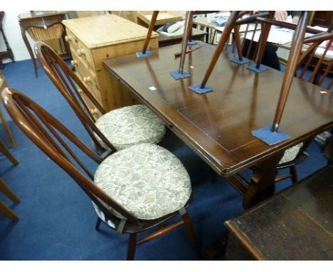 AN ERCOL DRAW LEAF TABLE, and six spindle back chairs including two carvers (7)