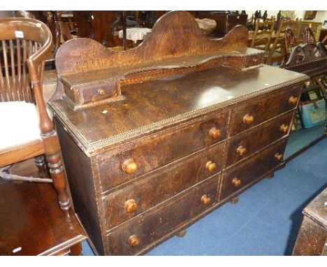 A VICTORIAN BRUSH GRAINED SIDEBOARD, the shaped raised back with shelf and two small drawers above six further drawers