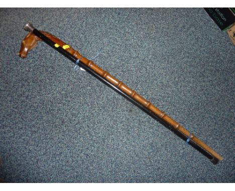 A SILVER TOPPED WALKING CANE, and a walking stick (possibly Pow St Helena 1901) (2)