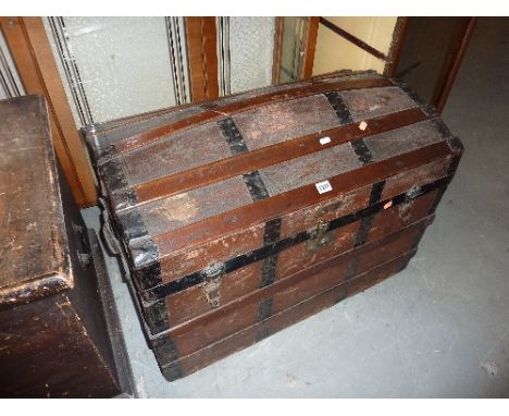 A DOME TOPPED METAL BOUND TRAVELLING TRUNK, (s.d.)