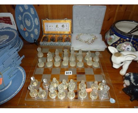 A CASED SET OF FOUR GLASS ORIENTAL SCENT BOTTLES, a glass chess set and cased necklace
