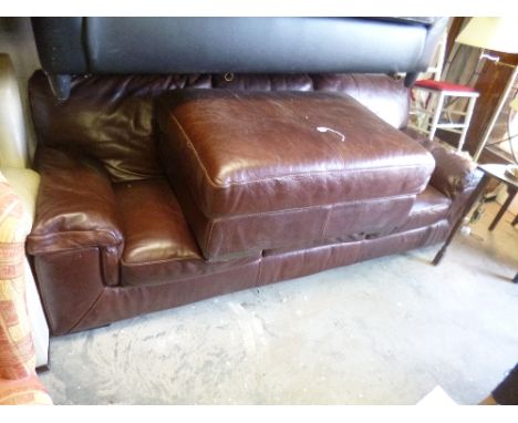 A LEATHER THREE SEATER SETTEE, and a matching pouffe