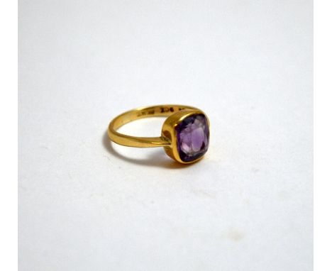 A RING, with single cushion cut amethyst with plain surround, to the plain tapered band, stamped 9ct, ring size N1/2