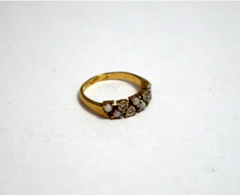 A 9CT GOLD OPAL AND DIAMOND RING, with single cut diamonds and circular shape opals in a band formation to the plain tapered 