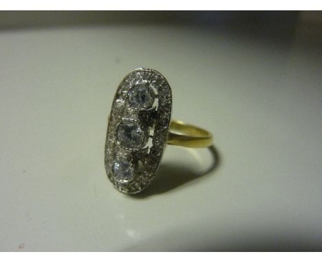 AN ART DECO STYLE SILVER GILT RING, with three cubic zirconia in an open work surround to the plain tapered band, unstamped/h