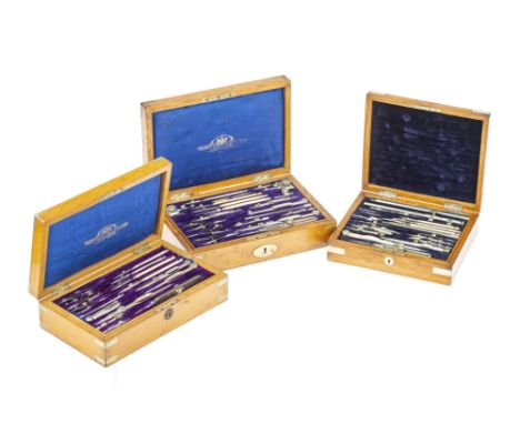 Three Sets of Drawing Instruments, Comprising of a set by Elliot, c.1880, French polished light oak with German silver bindin