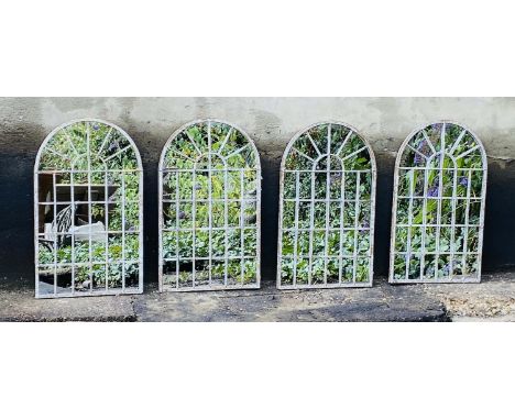 ARCHITECTURAL GARDEN MIRRORS, a set of 4, arched tops, aged metal frames, 60cm x 36cm. 