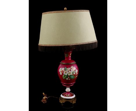 Porcelain table lamp with painted flower decoration, set in copper frame, with upholstered shade, 73 cm high (base not horizo